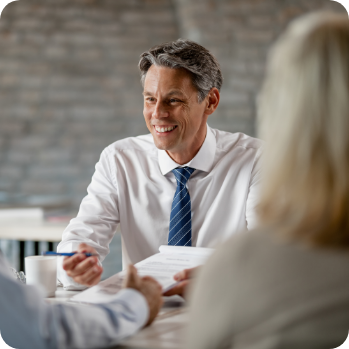 smiling Fractional CFO from Optima Office, talking with coworkers