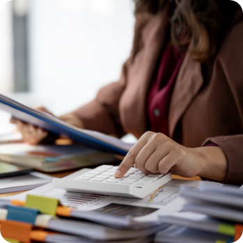 female business professional using a calculator, representing Outsourced Accounting Services